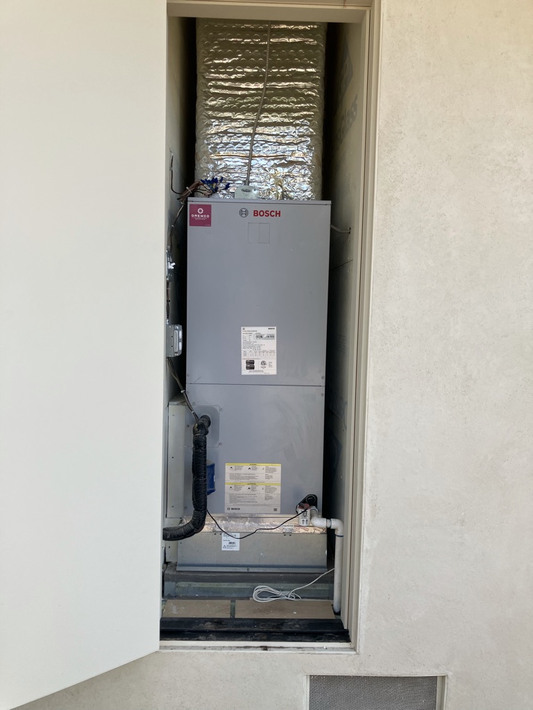 Experienced HVAC technician testing furnace controls and airflow with professional diagnostic tools