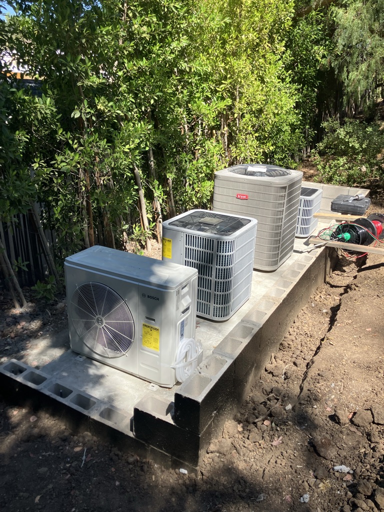 HVAC technician testing electrical and airflow components on a malfunctioning central air system
