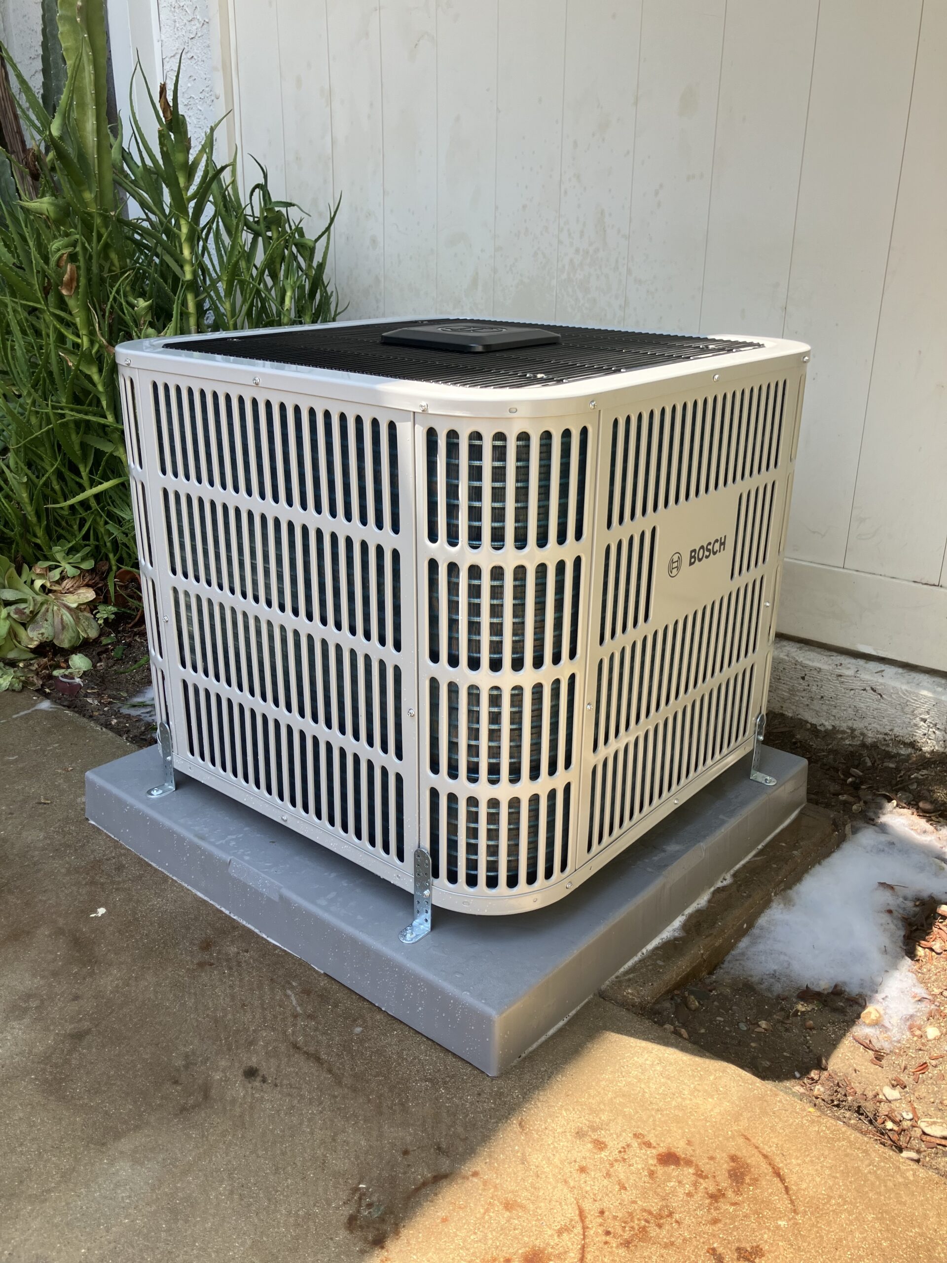 HVAC installer measuring airflow and checking system connections during new central air setup