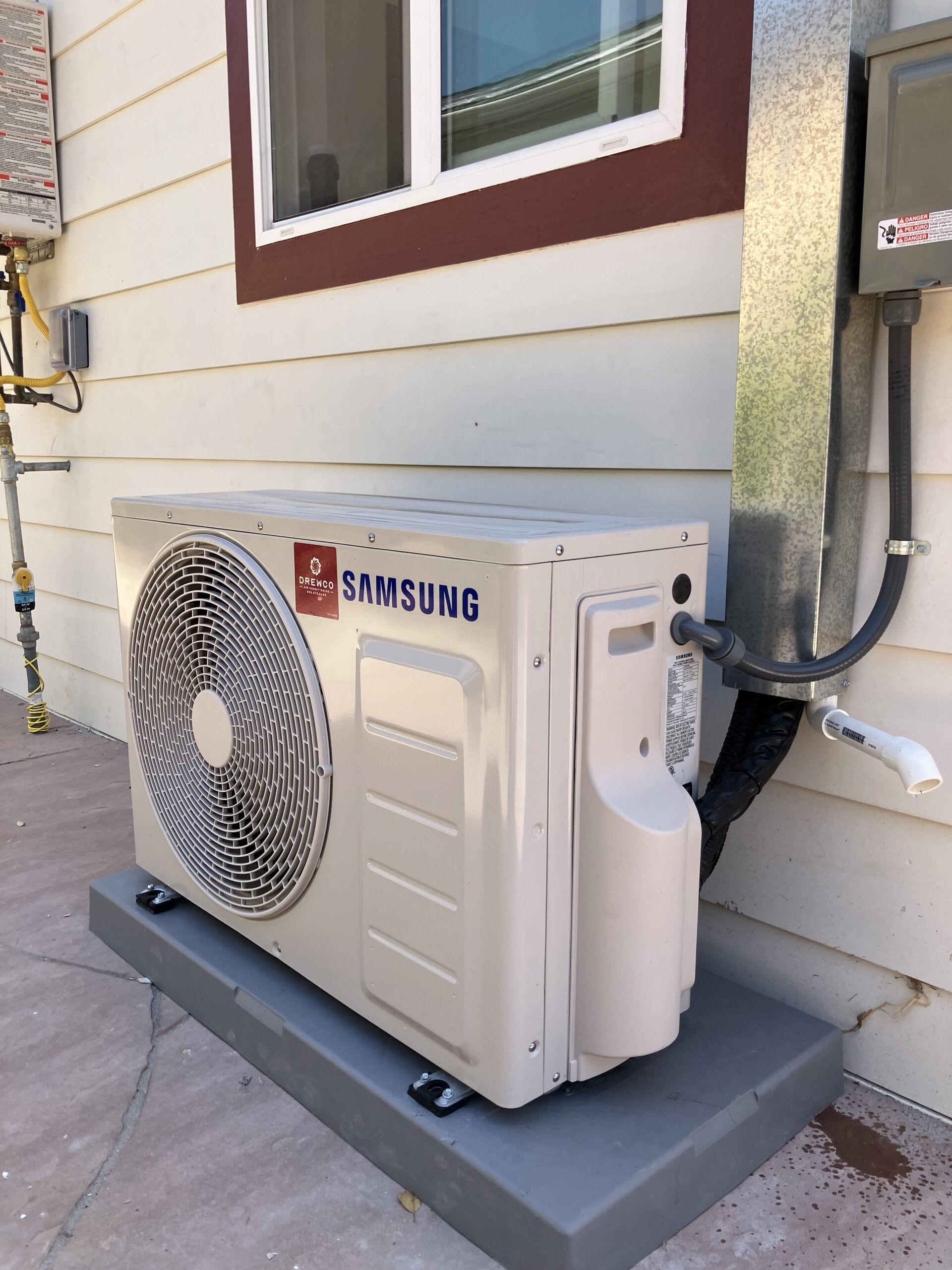 HVAC installer measuring airflow and checking system connections during new central air setup