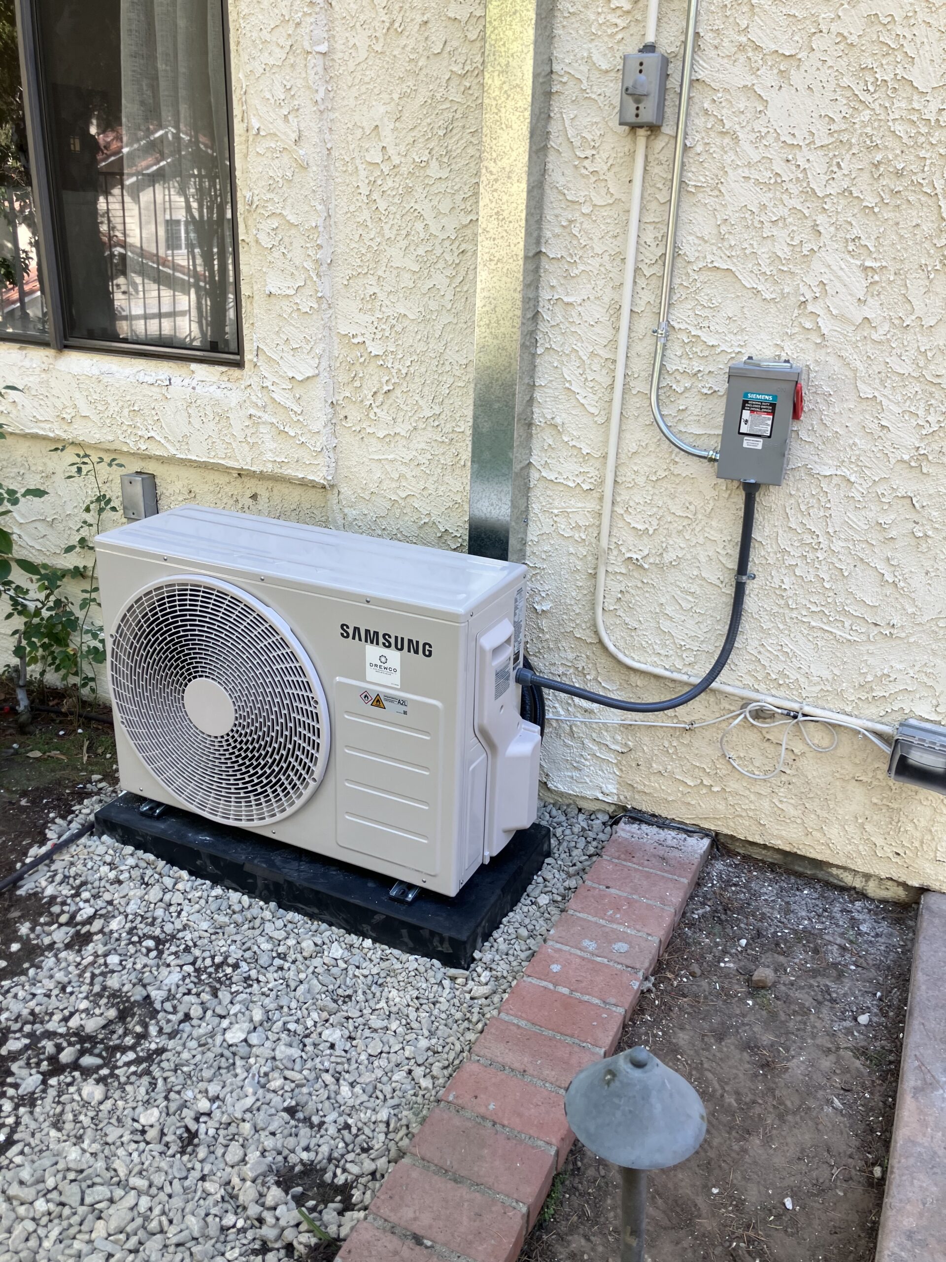 Technician configuring multi-zone mini split system with precise line and control setup