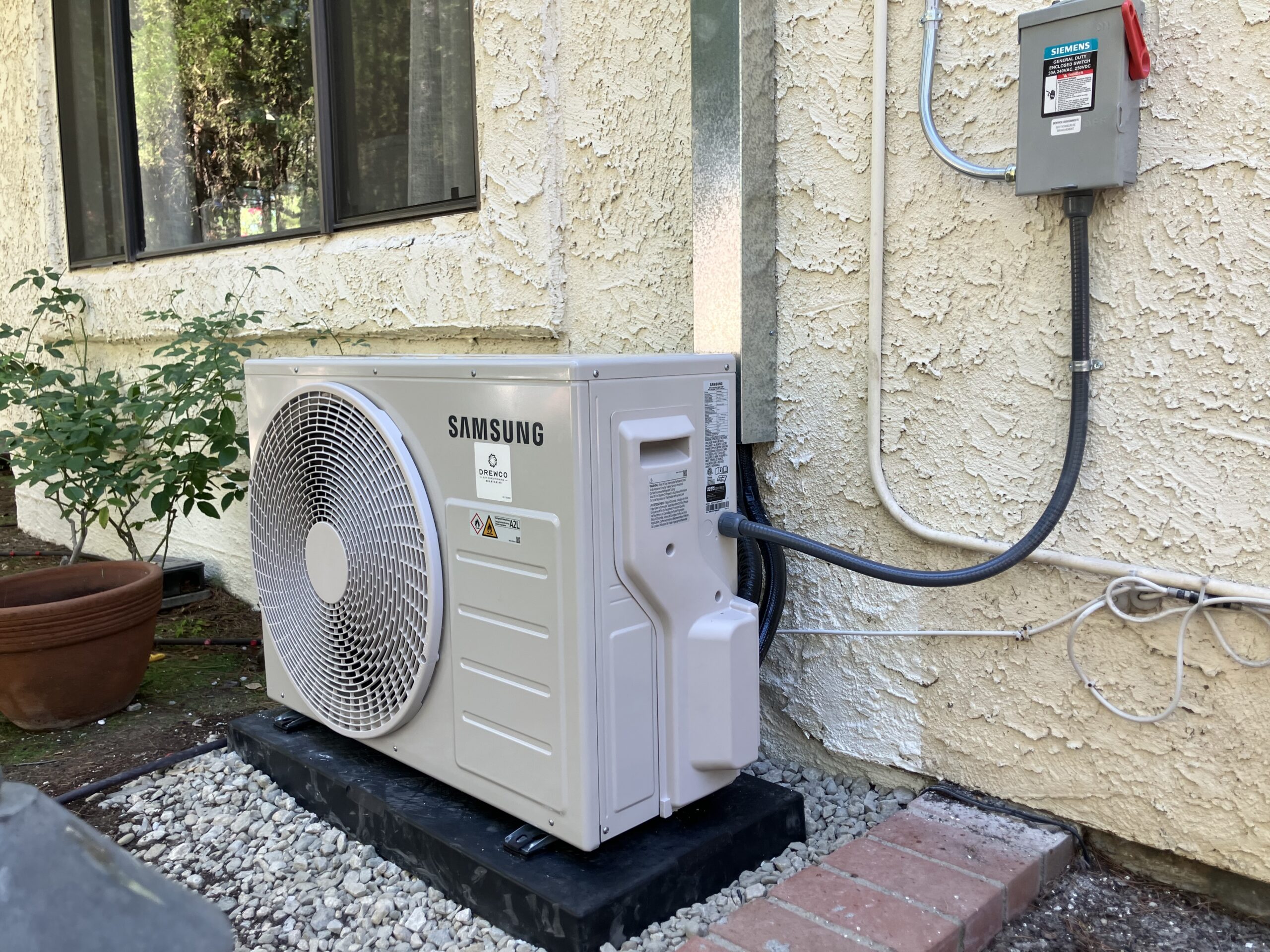 Technician configuring multi-zone mini split system with precise line and control setup