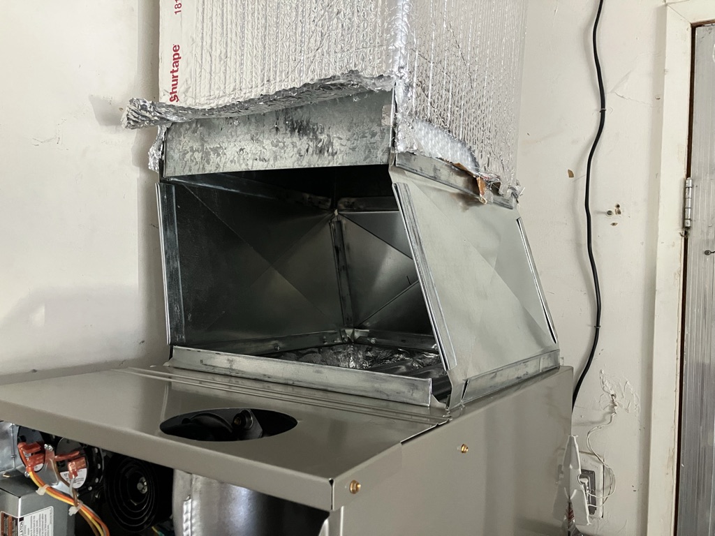 Technician diagnosing a residential furnace after homeowner reports no heat on a cold morning