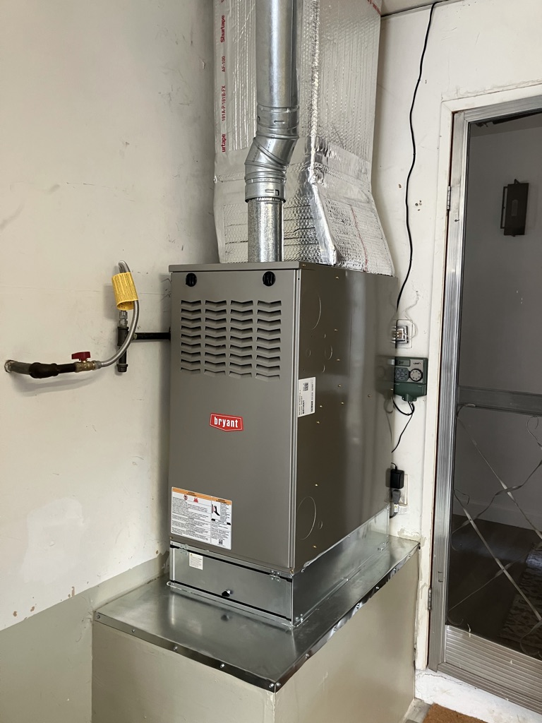 Experienced HVAC technician testing furnace controls and airflow with professional diagnostic tools