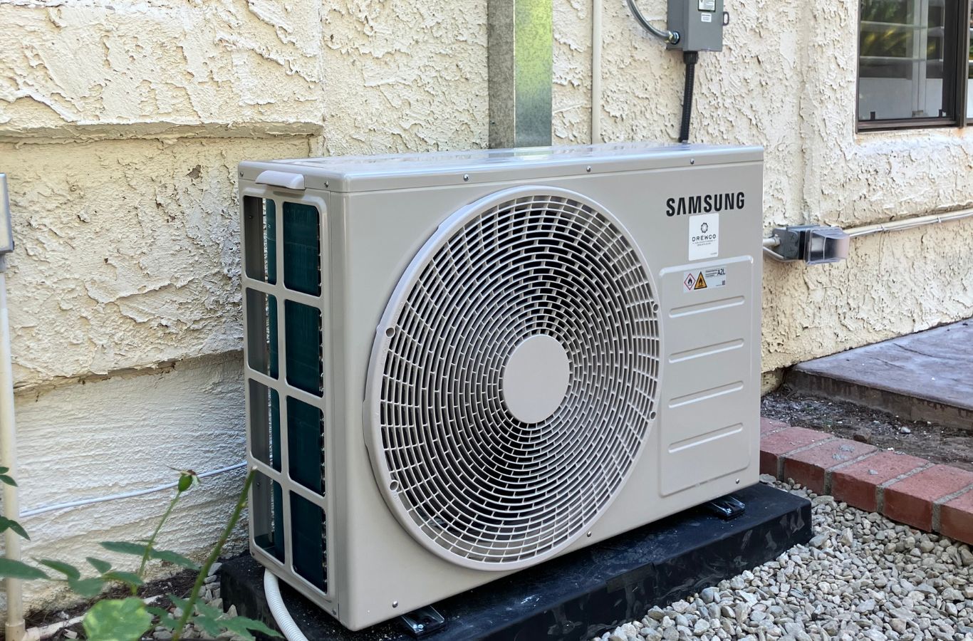 Specialist performing AC repair diagnostics inside a Calabasas - CA home using electrical testing equipment. AC Repair near me.