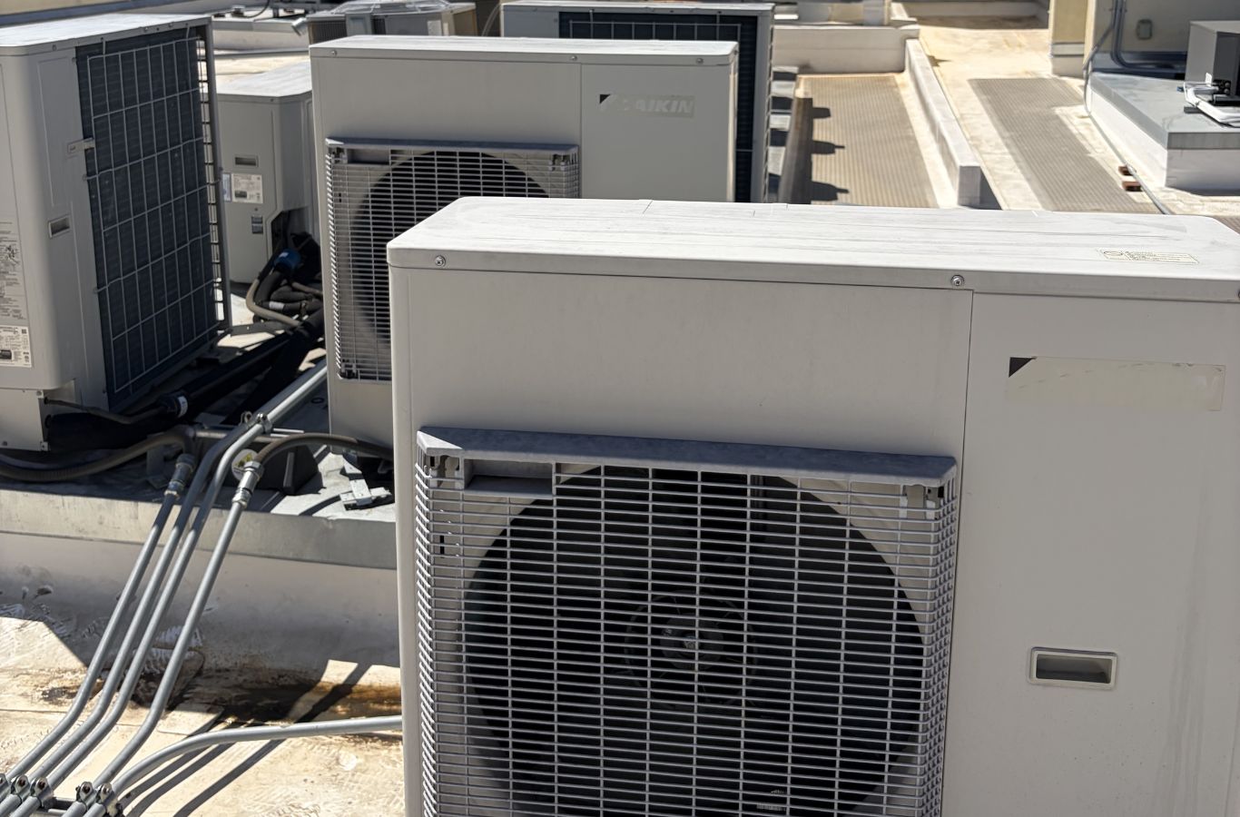 Technician diagnosing failed air conditioner during hot Ventura County afternoon service call