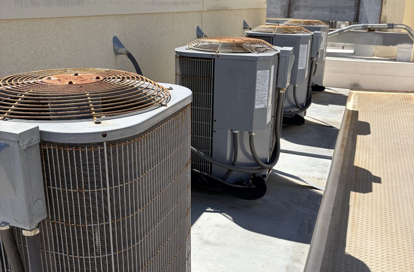 HVAC technician testing electrical components and airflow on malfunctioning central air system. AC Repair near me.